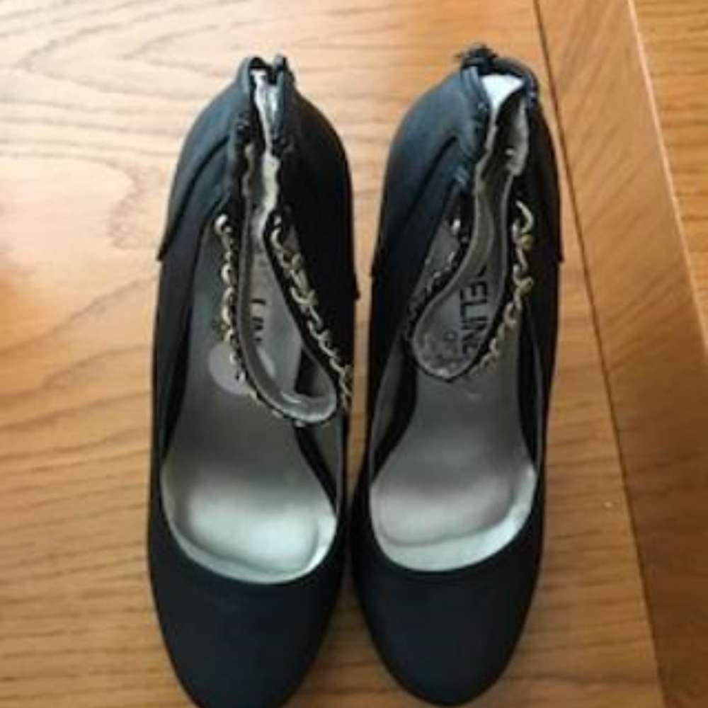 Black shoes with gold strap around ankle